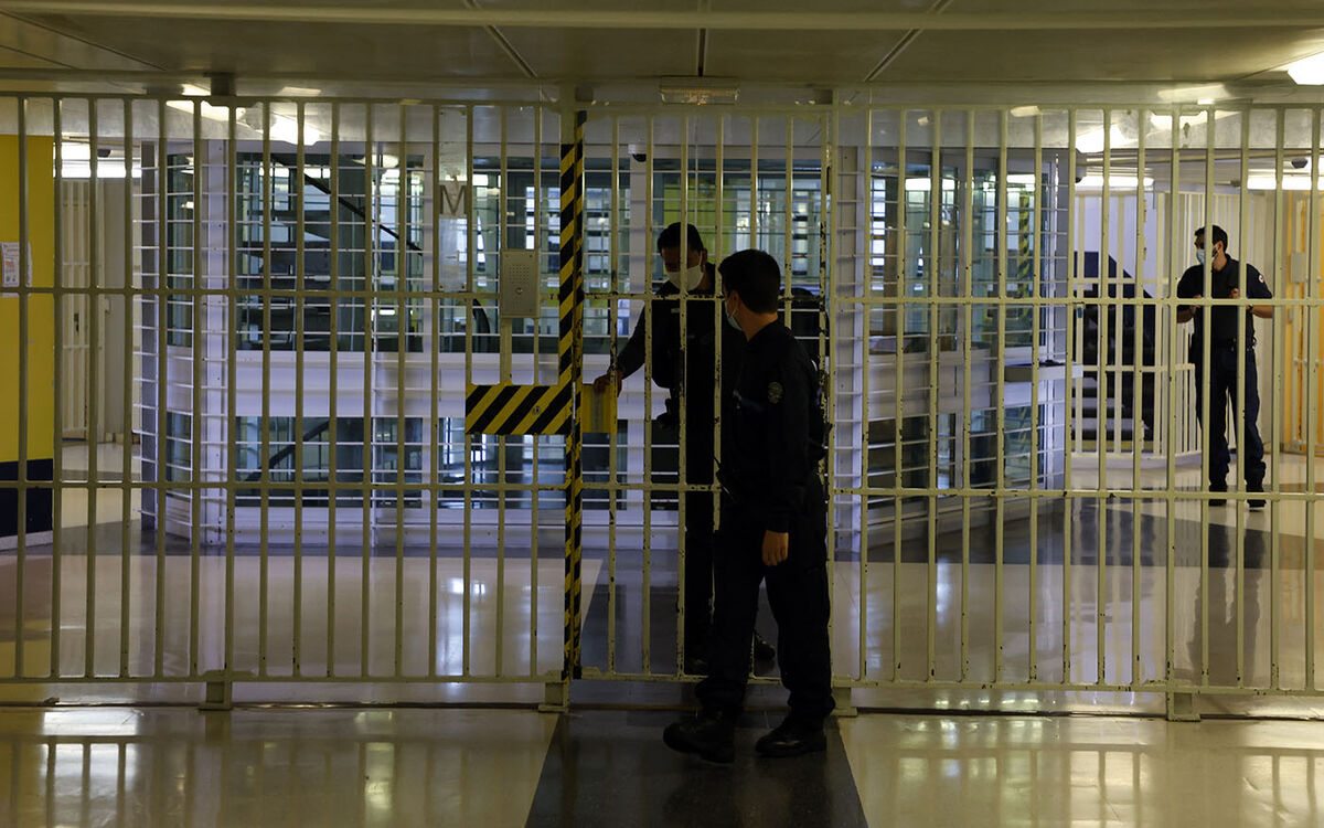 Penitentiary supervisors stand at a door in the D2 cell division at the Fleury-Merogis prison, in Fleury-Merogis, on the outskirts of Paris, on September 15, 2021. - This is the largest prison in Europe. (Photo by Ludovic MARIN / AFP)