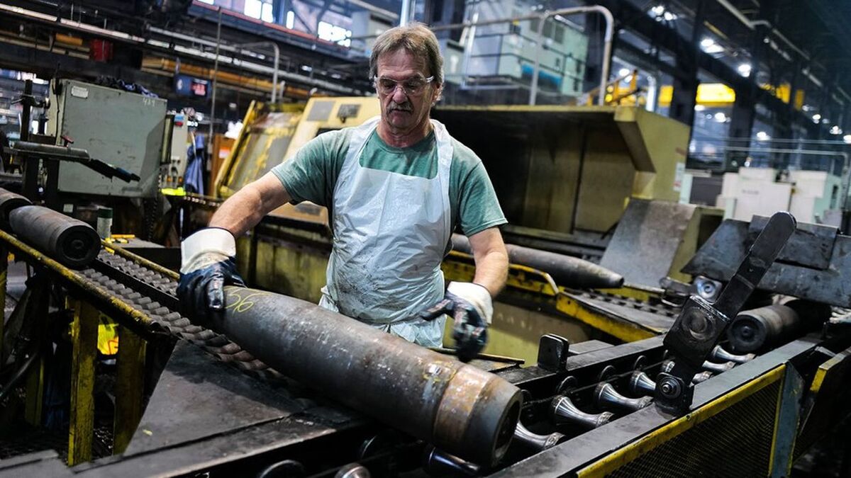 An employee handles 155 mm caliber shells after the manufacturing process at the Scranton Army Ammunition Plant (SCAAP) in Scranton, Pennsylvania on April 16, 2024. In brick buildings that are more than a century old, nearly in the heart of Joe Biden's Rust Belt hometown of Scranton, Pennsylvania, dated machinery churns artillery for modern conflicts, especially the war in Ukraine. The Scranton Army Ammunition Plant (SCAAP) is making steel tubes for 155 mm caliber shells, which are crucial to Kyiv's efforts to face down Moscow's invasion. (Photo by Charly TRIBALLEAU / AFP)