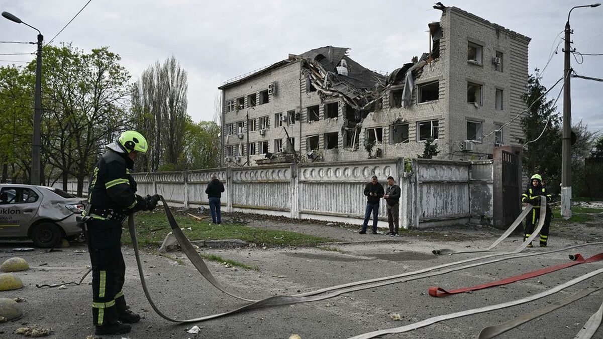Firefighters work at a site following a Russian strike in Kyiv on April 16, 2026, amid the Russian invasion of Ukraine. Russian strikes killed at least 12 people in Ukraine, local authorities said on April 16, after Moscow pummelled its neighbour in overnight attacks. (Photo by Genya SAVILOV / AFP)